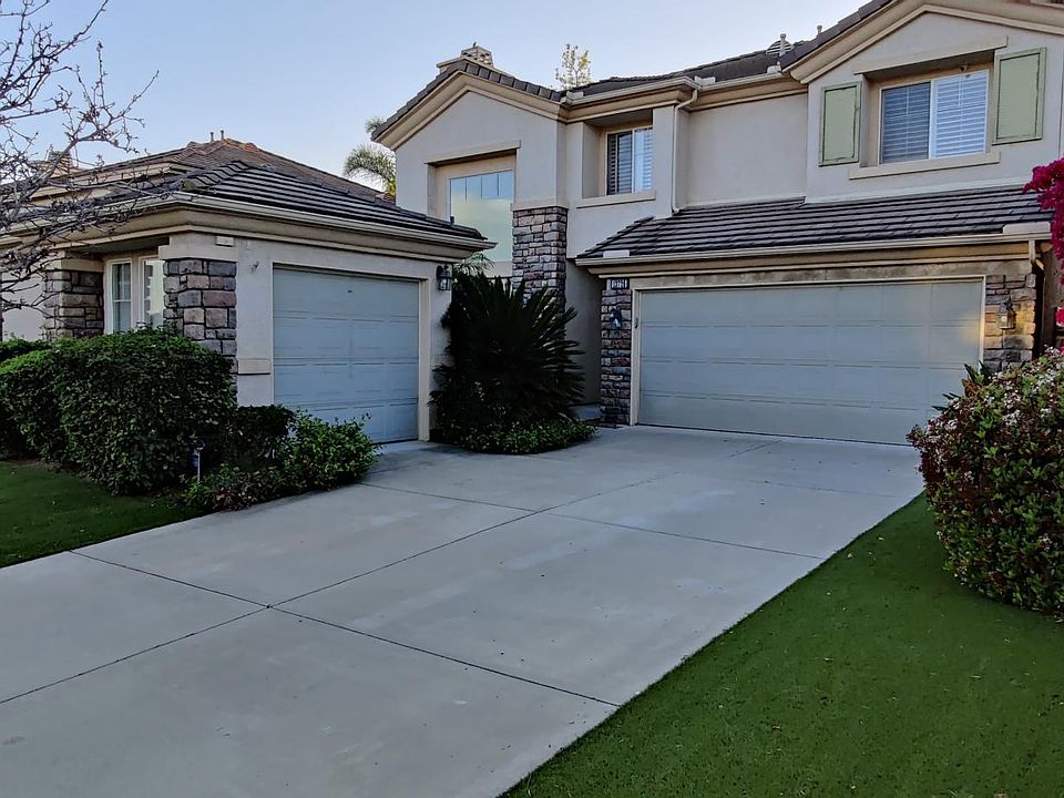 Front yard, spacious drive way and artificial turf