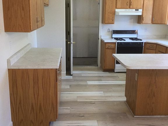 Kitchen, looking from dining room through to garage.