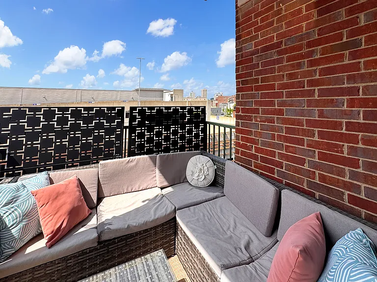 Back patio with sectional and privacy screens included with rental
