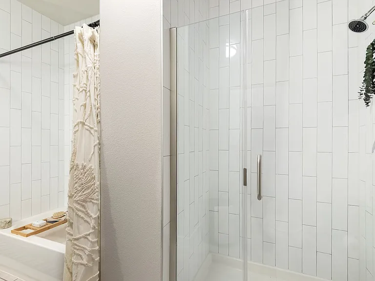 Glass-Enclosed Shower with Vertical Subway Tile Design