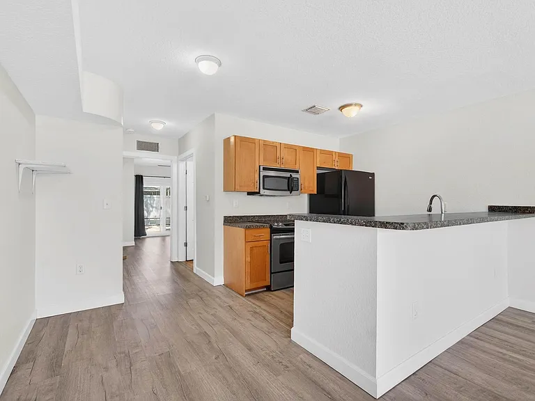 Kitchen opens to living room with option for bar stools at counter.