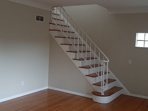 Living room, spacious, with lots of natural light and beautiful hardwood floor.