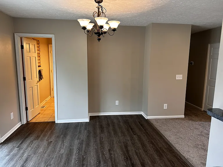 Dining area with a five light fixture, and a nook for small sideboard.