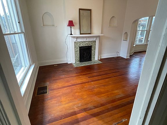 Stepping into living room from foyer. Large window lets in morning sun. Enjoy the garden view. All windows have cellular shades to filter light, and make the home cozy!