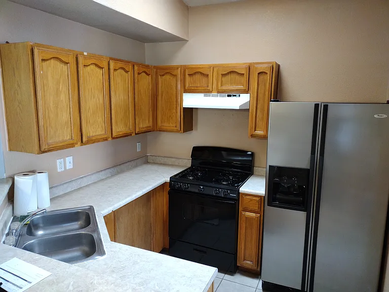 Kitchen with new stove and refrigerator