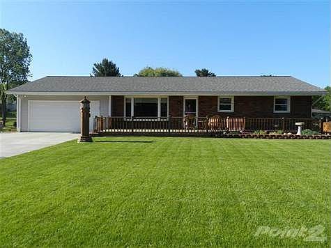 Lovely, well kept, brick and vinyl ranch has both front and rear decks, attached two car garage and another over sized garage.