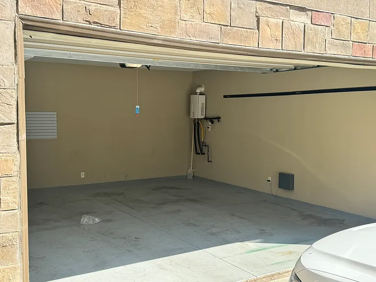 2 car garage with extra storage space. Tankless water heater and central vacuum.