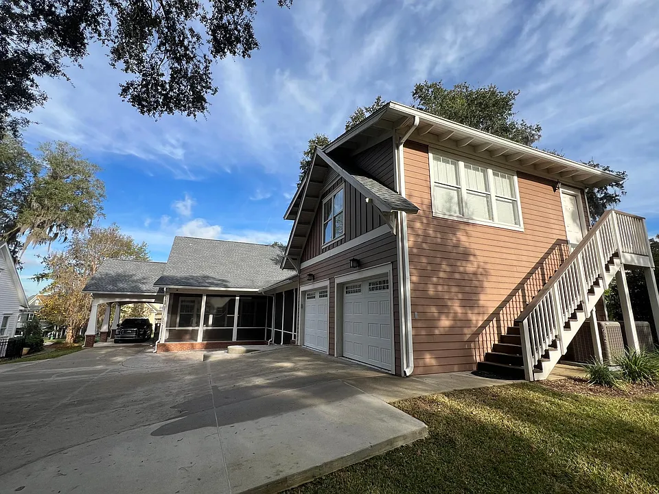 Photo of the Exterior. The carriage house sits atop the garage.