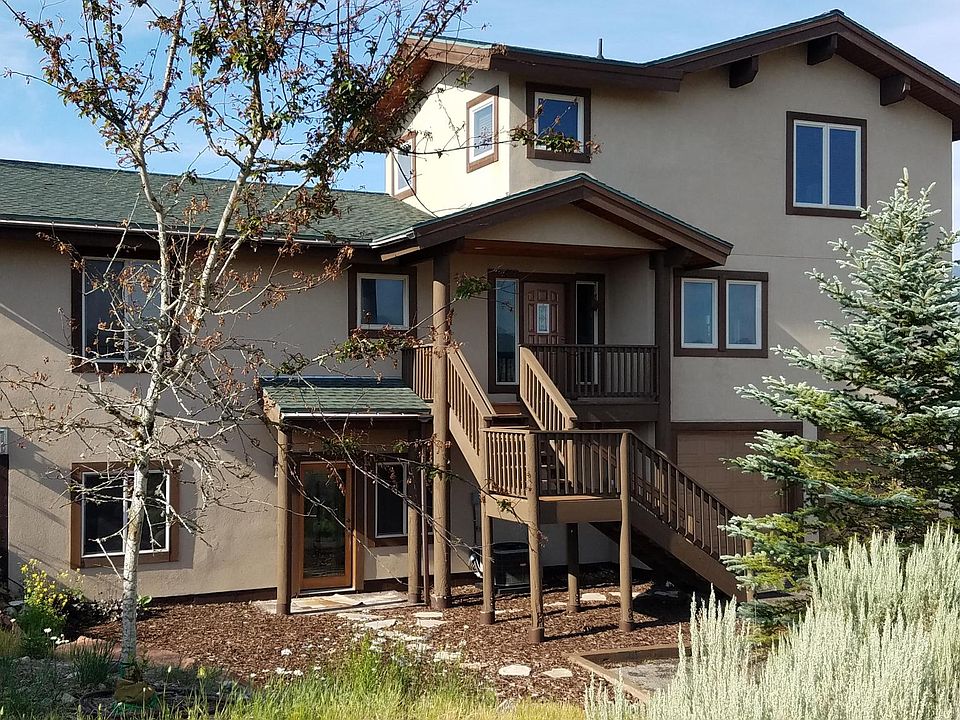 House front. Garage and driveway to right, optional apartment on left. Living area on 2nd floor with master bedroom on 3rd floor