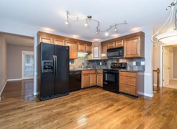 Gorgeous kitchen with lovely hardwood flooring.  Kitchen has been renovated in the past few years including cabinetry, counter, backsplash and lighting.  All appliances stay including smooth-top electric range, built in microwave, dishwasher and refrigera