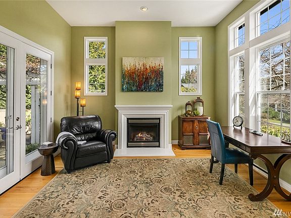 Formal sitting room with gas fireplace and French doors leading to the private courtyard. 