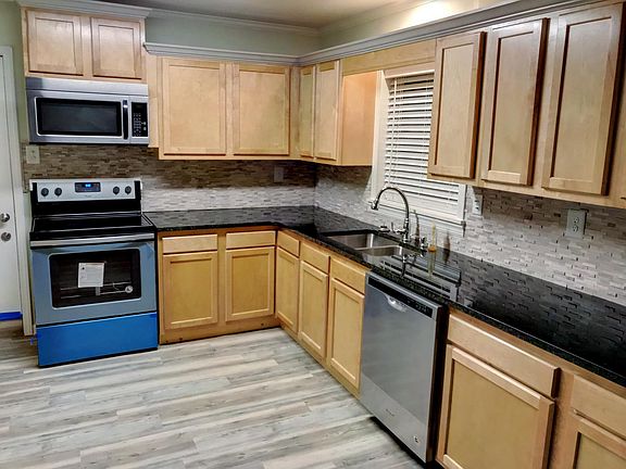 Kitchen features granite countertops, new cabinets, flooring