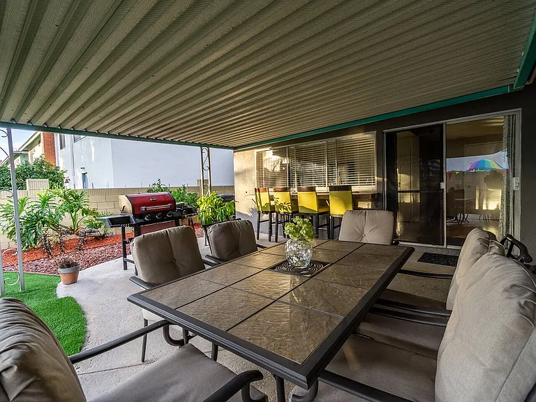 The big covered patio. All the patio furnitures plus the barbeque grill can all fit here. The sliding door leads to the kitchen on the left and family/tv room on the right.