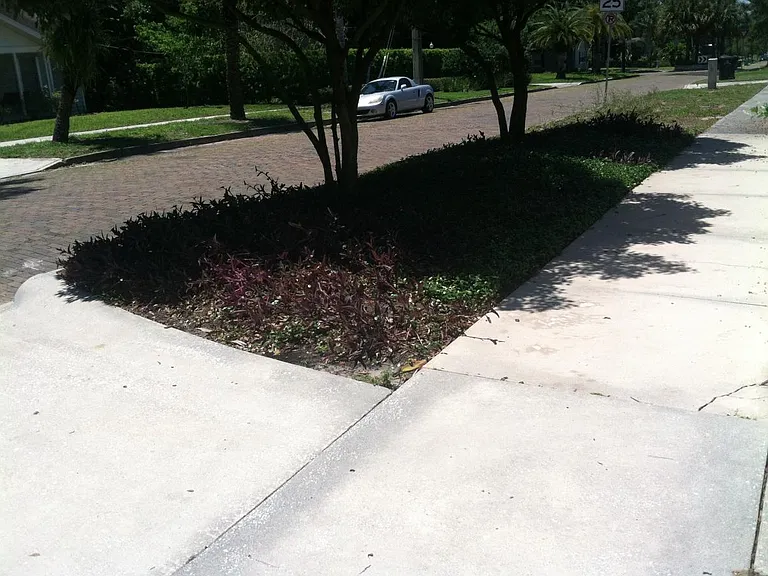 looking down the street the other way from the sidewalk