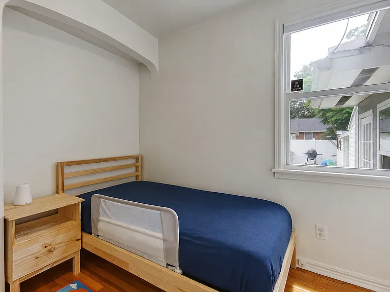 Bedroom 1: Looks into the backyard. Unique arch cut out and custom shelves, this room can be a kids room, workout area, or home office