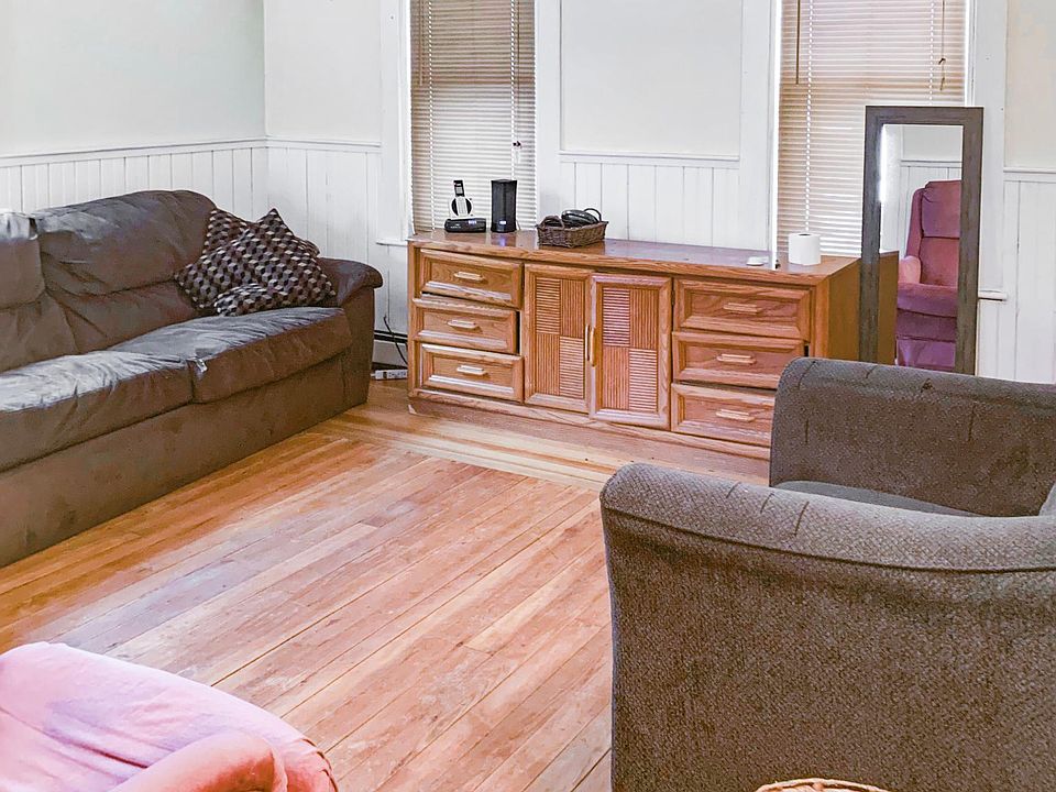 Living room. The house comes MOSTLY furnished if you'd like that; we will move furniture out if needed. There is a bed in only ONE of the 3 bedrooms at this time. We will discuss putting more beds in if needed.