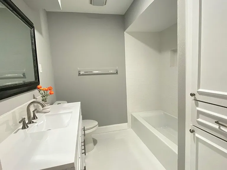 Hall bathroom with a brand new vanity and tub.