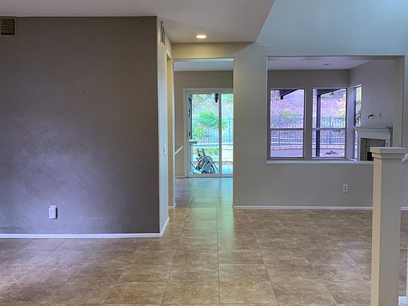 Entry of home with accent wall at formal dining space