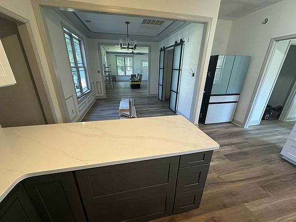 Fridge will have cabinet above it and beside it.