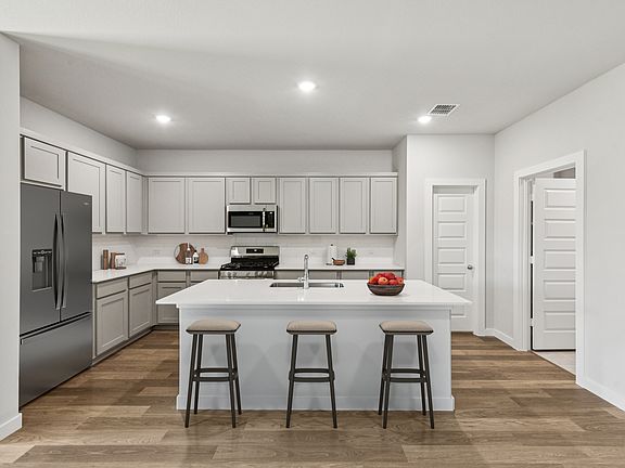 Kitchen in the Oscar home plan by Trophy Signature Homes - REPRESENTATIVE PHOTO