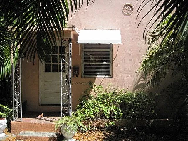 Old Chicago brick entry framed by mature palms