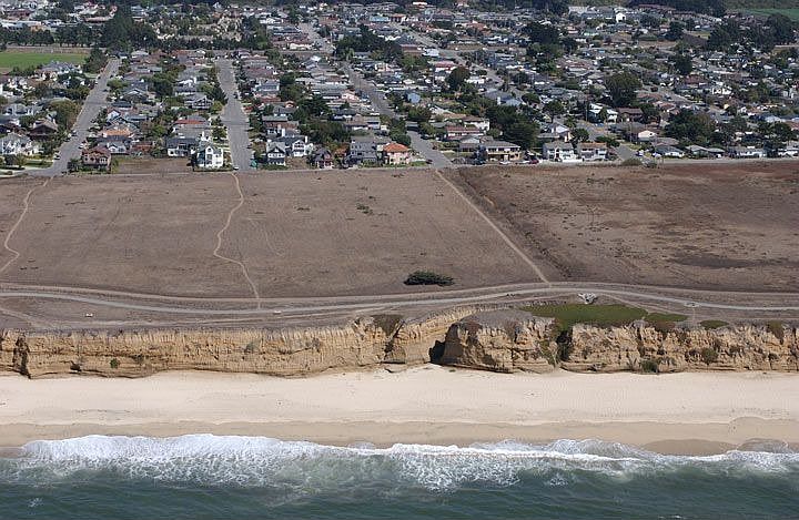 Aerial view of beach, bluffs, and home