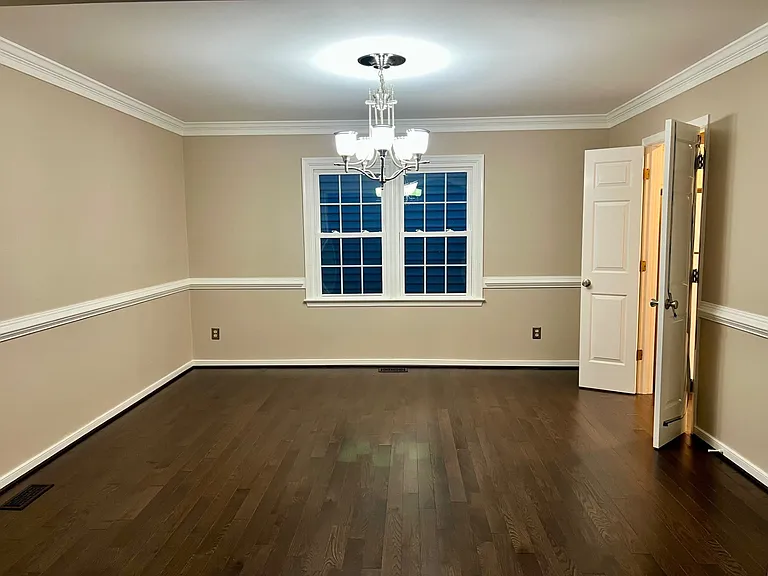 Dining Room with double French doors leading to kitchen. Recently repainted to neutral colors