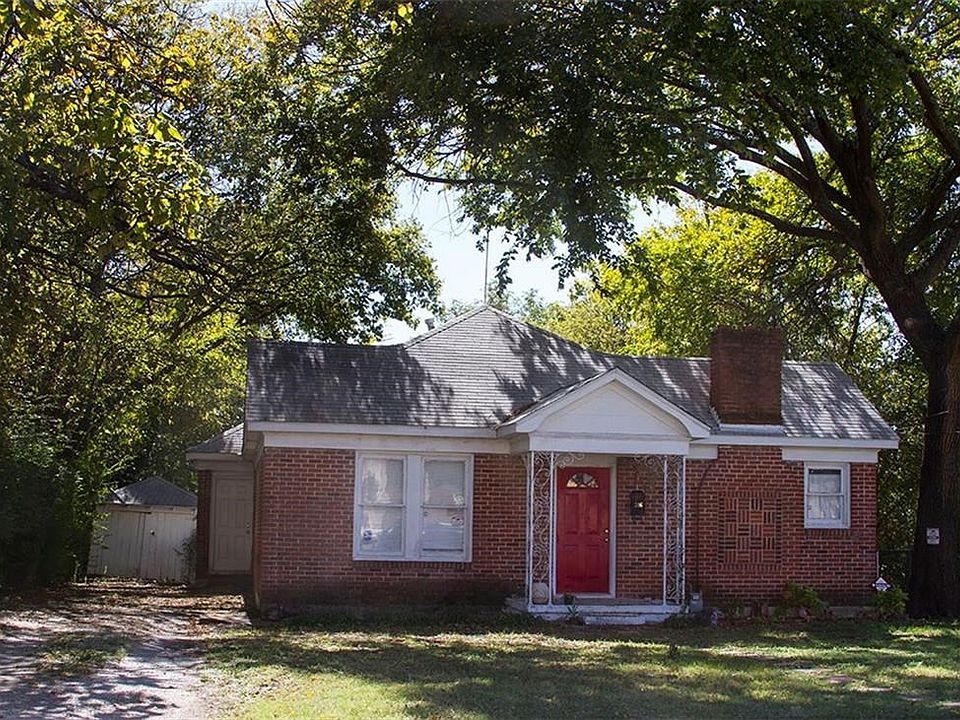 Front of the home with magestic Oaks in the Heart of Old Richardson.