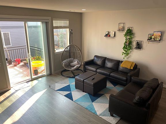spacious bright lit living room that opens to a deck