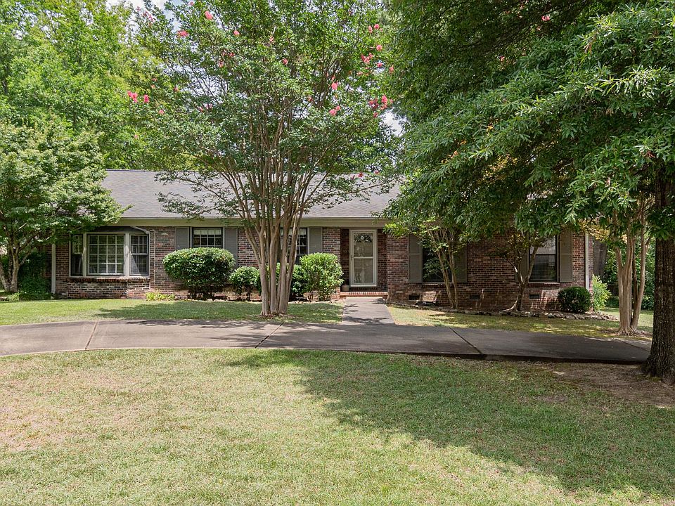FRONT VIEW WITH CIRCULAR DRIVE ON A DEADEND STREET, VERY WALKABLE TO PUBLIX, BAKERY, SHOPS, PARK, POST OFFICE, CHURCHES AND RESTAURANTS