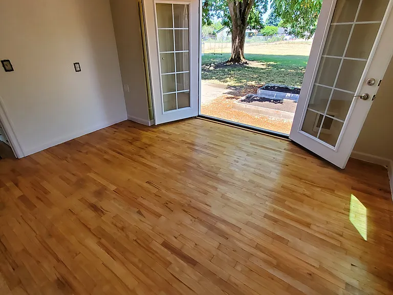 Master Bedroom refinished original floor and French doors to backyard.