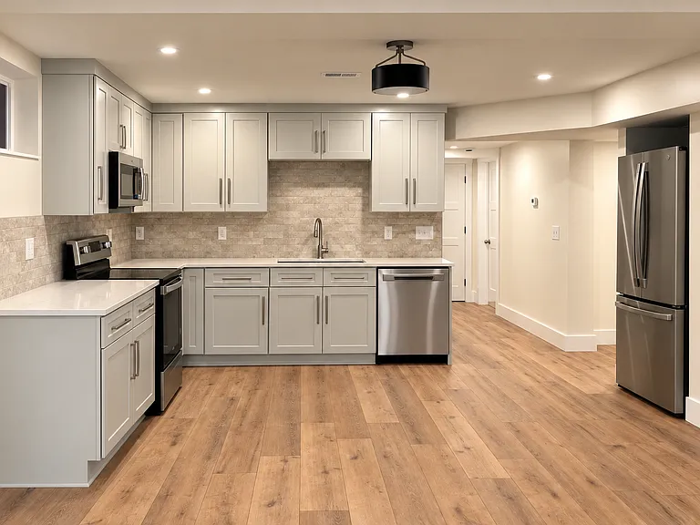 The spacious eat-in kitchen offers plenty of room for dining and features ample cabinetry along with a convenient pantry for extra storage and organization. Quartz countertops and a sophisticated backsplash dress up the space.