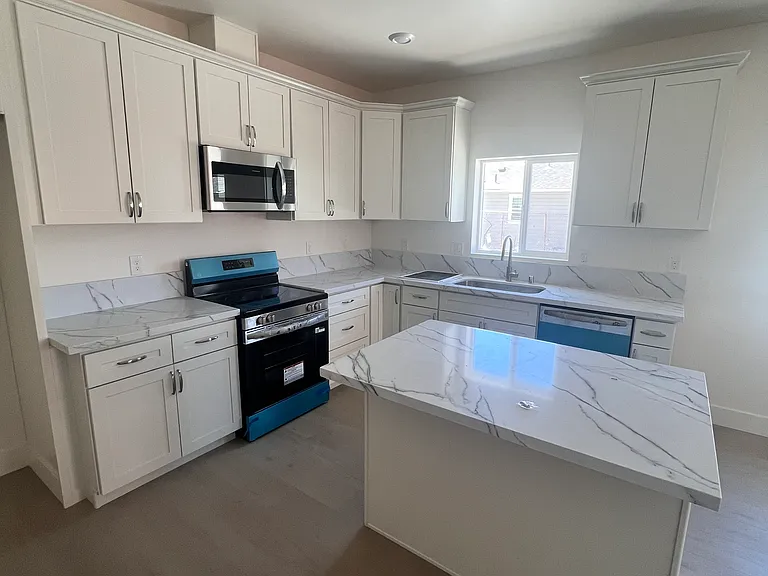 Good sized kitchen with new cabinets, counter tops, and stainless steel appliances. And an island for more work space!