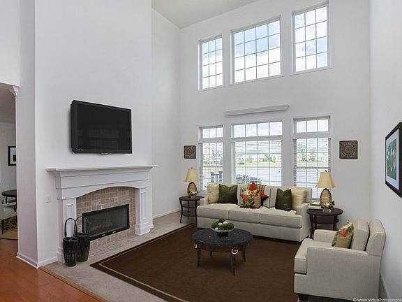 An expansive great room that offers amazing views! The fireplace makes a great focal point and you get twice the effect by having it be a double sided unit - so you can enjoy from 3 rooms!
