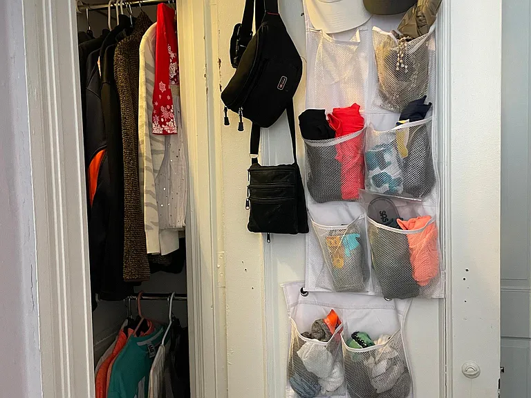 Closet with 3 hanging rods and 2 shelves.