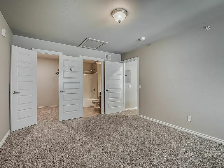 Explore the expansive bedroom with ample storage and a cozy atmosphere.