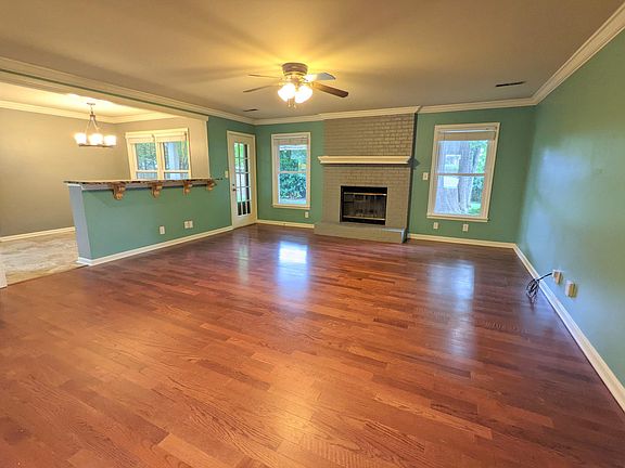 Open Living Room and Eating Area with Bar and Wood Burning Fireplace