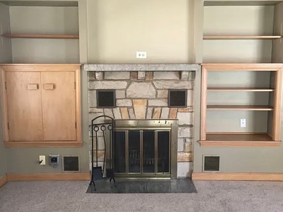 natural wood burning fireplace in the living room