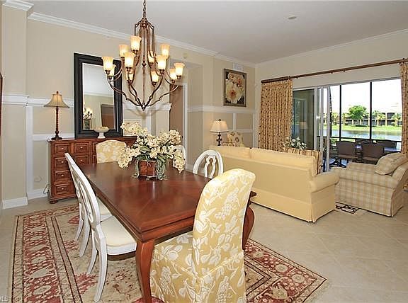 Gorgeous Dining / Living Room area. Tile on the Diagonal. Crown Molding throughout.