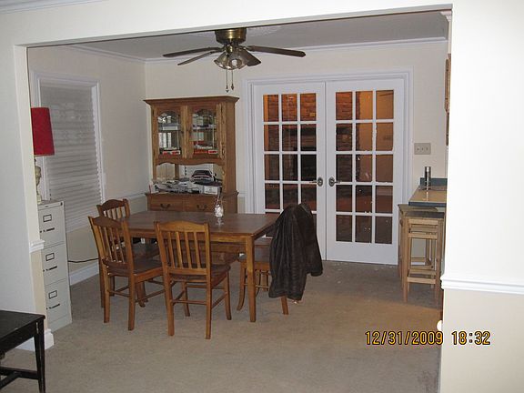 Dining Room looking through French doors into the Family Room and Fireplace