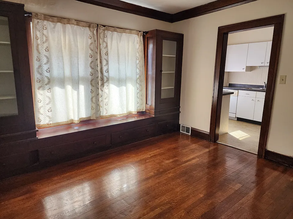 Spacious Dining Room with Hardwood floor and built-in cabinets. Curtains included