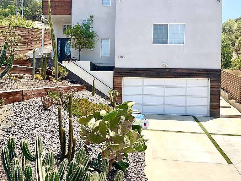 Three-level house with 2-car garage, front patio, backyard, and wrap-around balcony