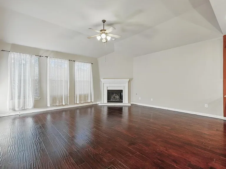 The bright and airy living room flows seamlessly into the spacious kitchen, creating an open-concept layout that's perfect for both everyday living and effortless entertaining.
