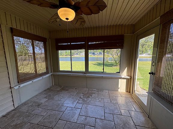 SUN-ROOM WITH SCREENED WINDOWS & LARGE LIGHTED CEILING FAN