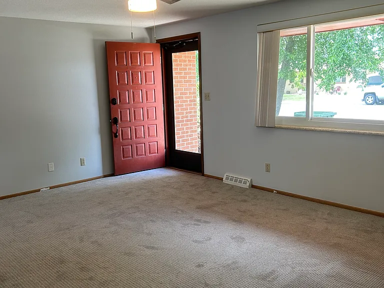 Front door, as you walk in the bright, large living room - new light gray carpet and paint