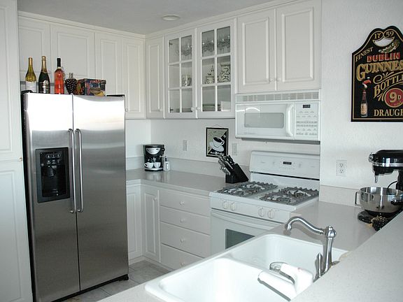 Kitchen with new stainless steel refrigerator and dishwasher.