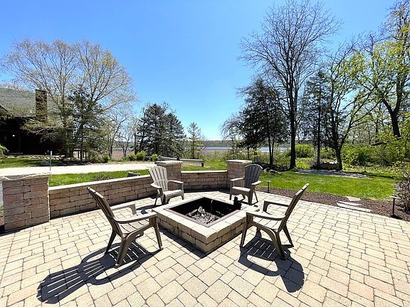 Enjoy the beautiful nature and lake views from your own private built in stone firepit.