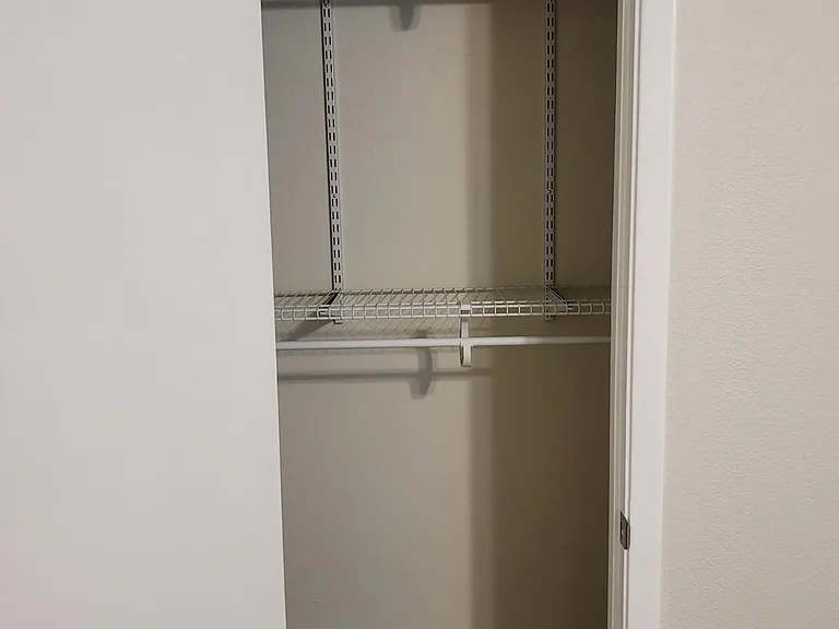 Second bedroom custom closet with plenty of storage space.