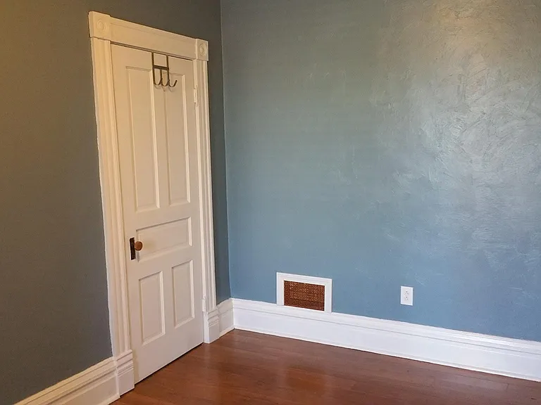 The smaller guest bedroom has a small closet inside.