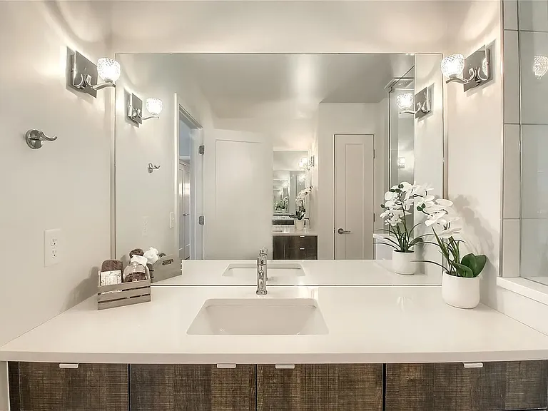 Double vanity mirroring one another in primary bathroom